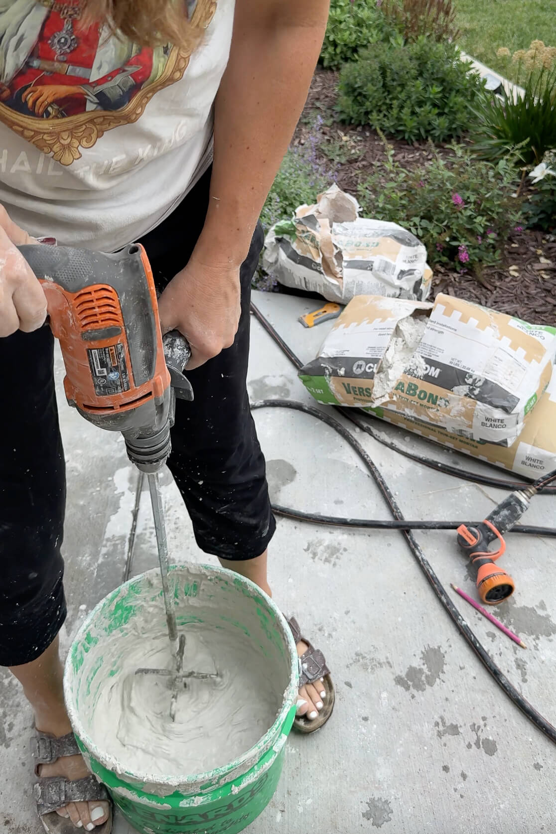 Mixing mortar to update a 1970s exterior rock wall.